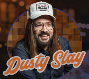 Comedian Dusty Slay wearing a hat with his catch phrase: "We're havin' a good time."