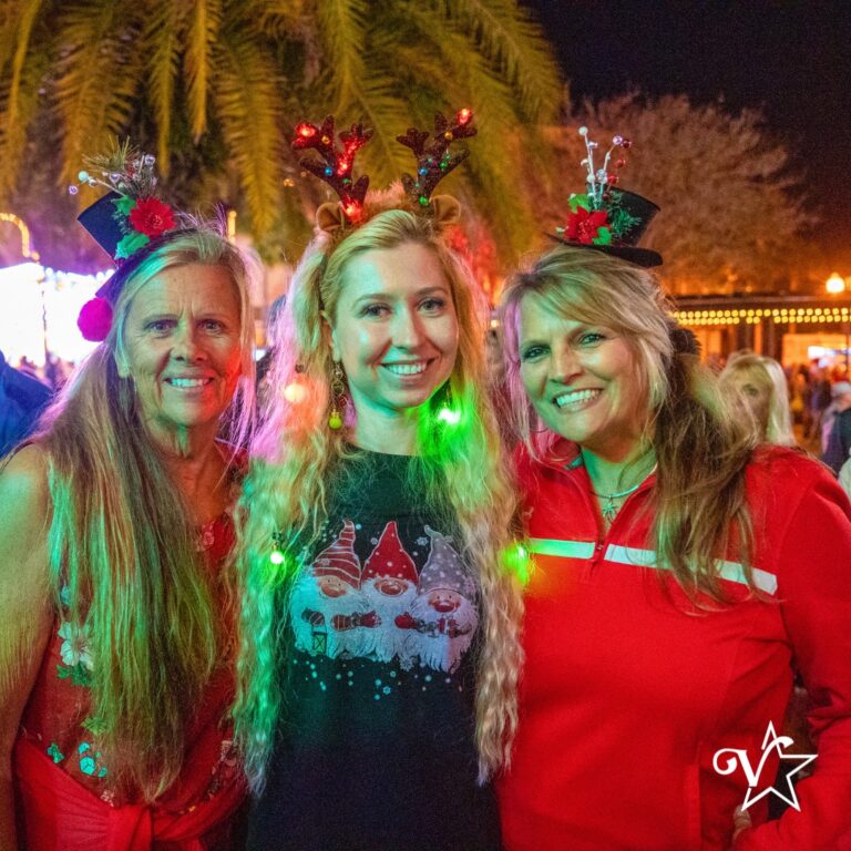Three people posing in Christmas Sweaters