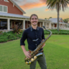 Ryan Thurgaland- holding instrument standing outside
