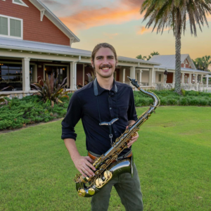 Ryan Thurgaland- holding instrument standing outside