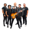 A band of 5 stand in a v formation. Zee stands in the front holding an orange guitar, eyebrow raised, pointing at the camera.