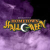 "Brownwood Hometown Halloween" Orange letters with the O in Halloween white and in the shape of a crescent moon with green bats flying through. The background contains purple smoke/fog.