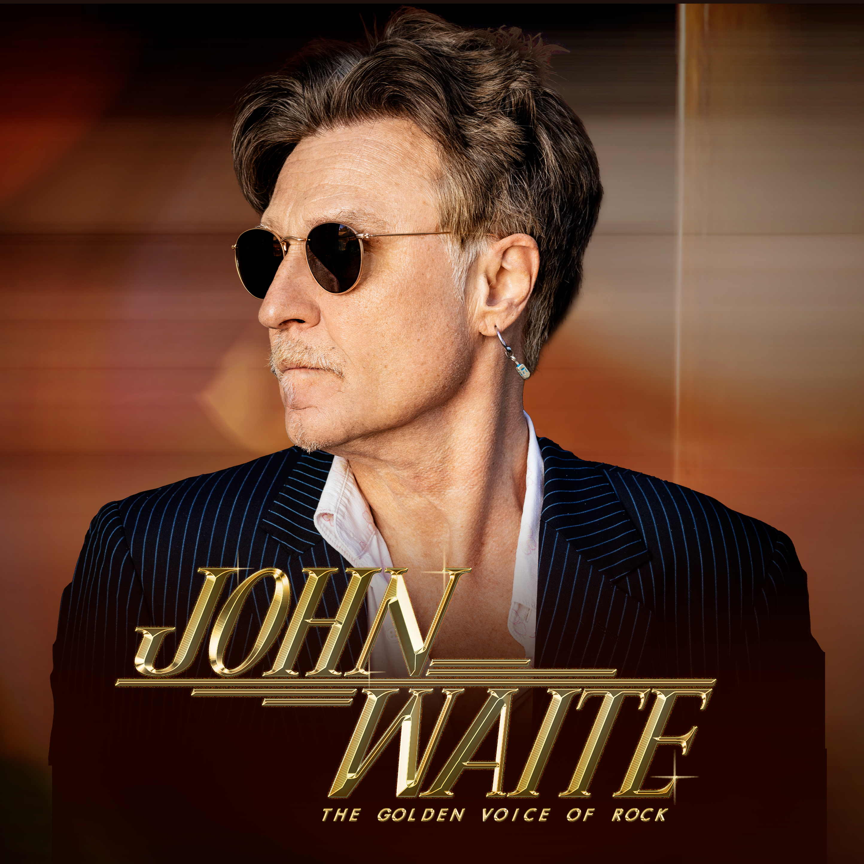 Promotional image of musician John Waite in a dark jacket against a black background. Bold text reads “John Waite.”