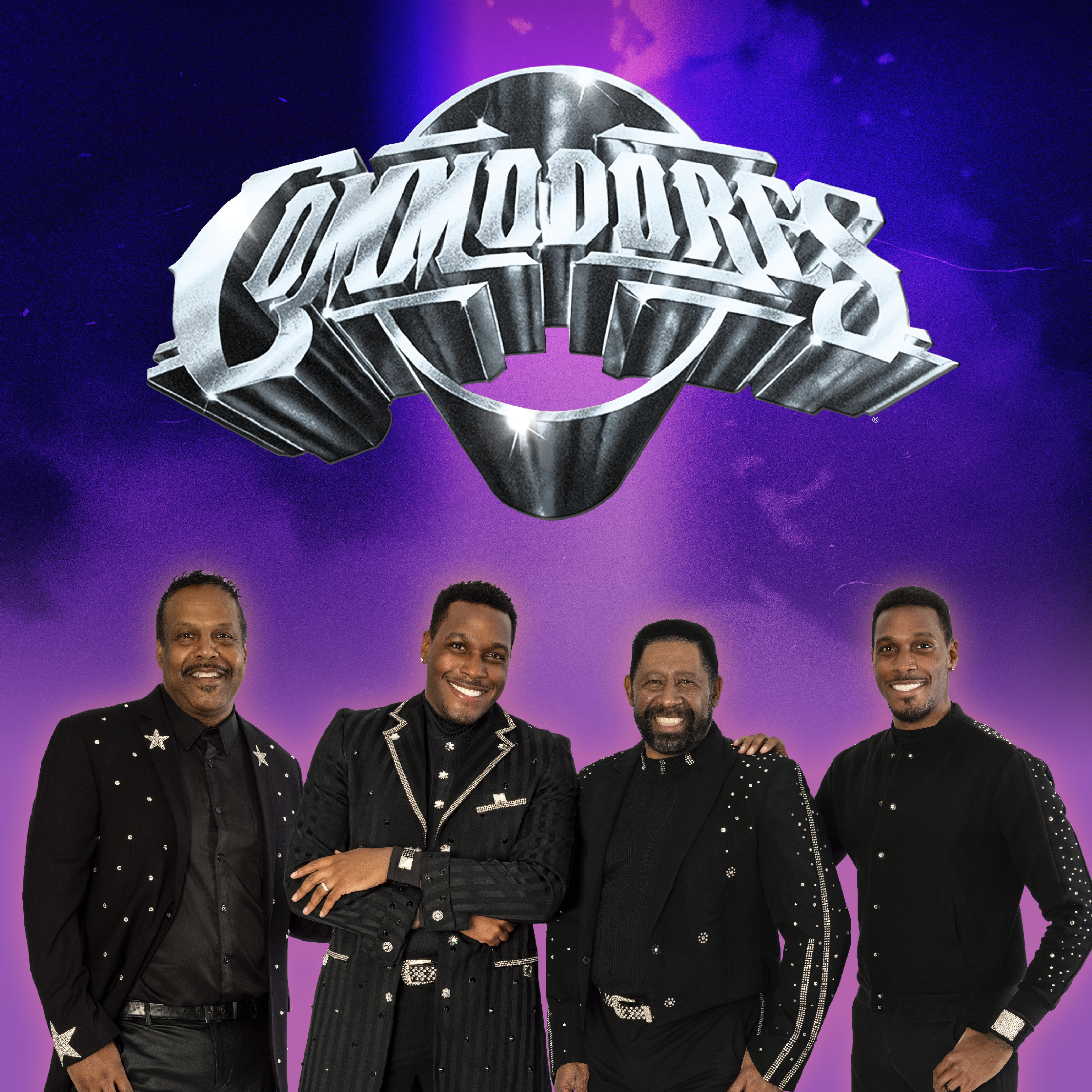 Four members of The Commodores stand smiling in front of a purple background with the band’s large metallic logo above them. They are dressed in coordinated black outfits with sparkling accents.