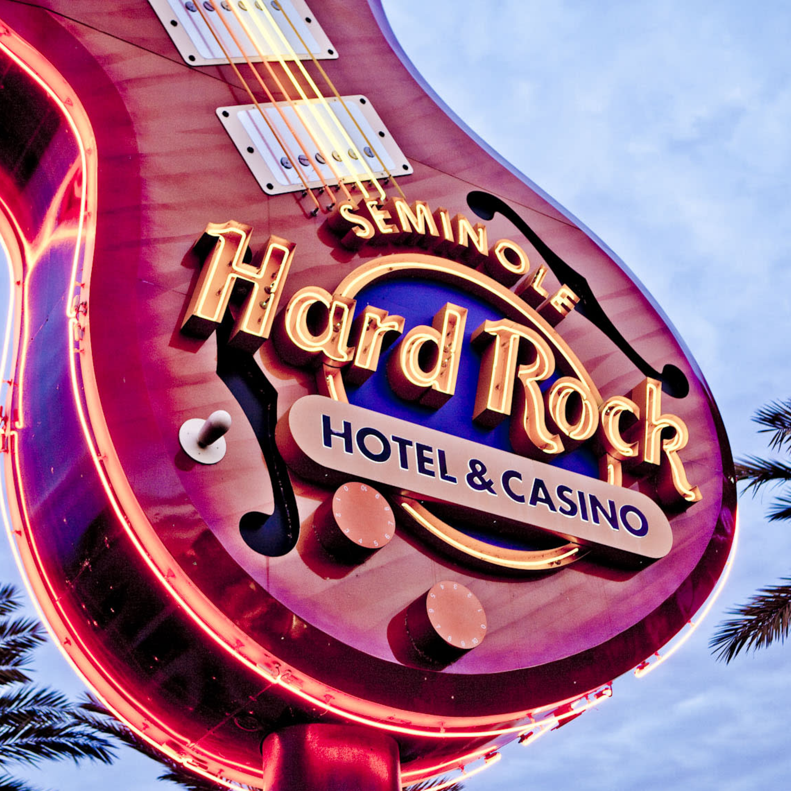 Guitar-shaped sign with neon light Seminole Hard Rock Hotel & Casino logo.