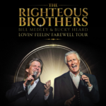 Promotional poster for The Righteous Brothers. Pictured are two performers singing into microphones. In gold, it reads "The Righteous Brothers."