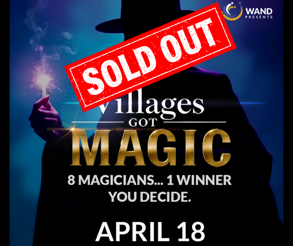 Promotional poster for "Villages Got Magic" showing a silhouetted magician in a top hat, holding a sparkling flame, against a blue background. White text reads "Villages Got Magic" with the word "Magic" in bold, gold letters and smaller text below reading: "8 magicians… 1 winner. You decide." A red "Sold Out" stamp overlays the top of the image. Event date shown as April 18, with the Wand Presents logo in the upper right.