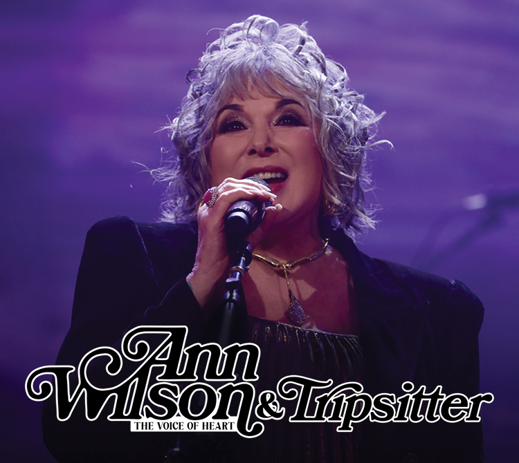 Promotional graphic featuring a performer singing into a handheld microphone on stage under purple lighting. Stylized text at the bottom reads “Ann Wilson & Tripsitter,” with smaller text reading “The Voice of Heart.”
