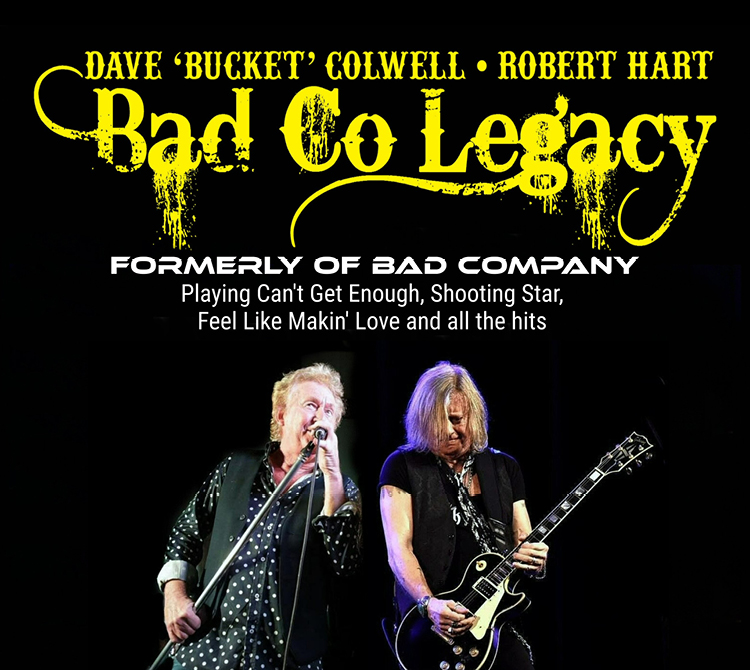 A promotional image with large distressed yellow text reading “Bad Co Legacy” across the top, along with smaller text naming “Dave ‘Bucket’ Colwell • Robert Hart.” Below, white text reads “Formerly of Bad Company” and “Playing Can’t Get Enough, Shooting Star, Feel Like Makin’ Love and all the hits.” At the bottom, two performers are shown onstage against a black background—one holding a microphone stand and the other playing a black electric guitar.