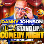Promotional poster for Wand Presents - "LOL" July Stand Up Comedy Night. A man wearing glasses is in front of a red show curtain. The image says "Danny Johnson, "LOL" Stand Up Comedy Night in The Villages.