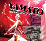 A promotional graphic shows a stage performer holding drumsticks during a live percussion performance, set against dramatic red lighting and layered drum imagery. Large stylized text reads “YAMATO: The Drummers of Japan.” A white compass is displayed in the bottom right corner.