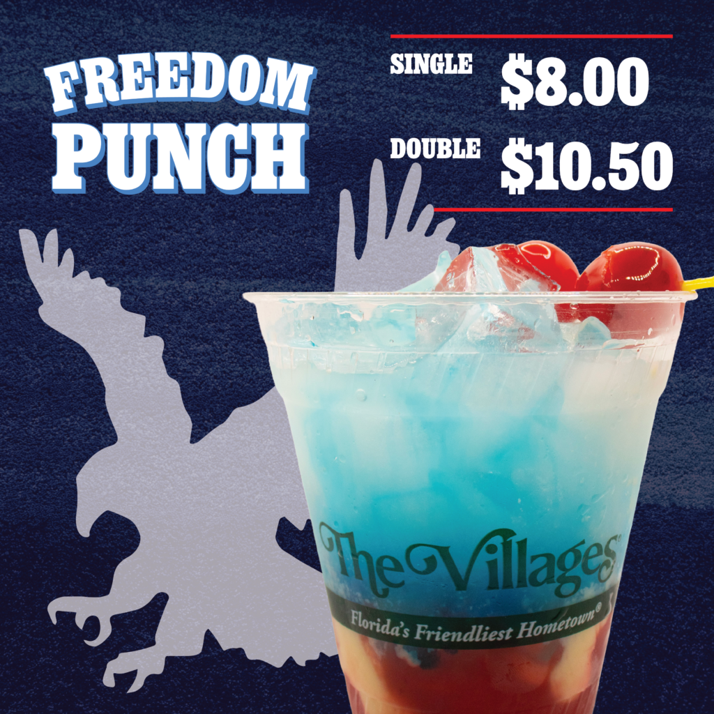 Promotional graphic for the Freedom Punch cocktail featuring a red, white, and blue layered drink served over ice in a clear plastic cup branded “The Villages – Florida’s Friendliest Hometown.” Two red cherries on a yellow cocktail pick garnish the drink. Large white text on a dark blue textured background reads “FREEDOM PUNCH.” Pricing is displayed in the upper right: “Single $8.00” and “Double $10.50,” separated by red horizontal lines. A large light-gray eagle silhouette appears behind the drink, reinforcing the patriotic theme.