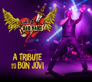 Picture of a performer on stage holding a microphone, covered in purple lighting. A heart with wings and a sword through it is on the left of the image. Livin' On A Bad Name" is written on the heart. "A Tribute To Bon Jovi" is written under the heart.