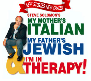 The design features a white background with bold, colorful typography. At the top, a red ribbon banner reads “New Stories New Chaos!” Below it, smaller red text reads “Steve Solomon’s.” Large stacked text dominates the center: “My Mother’s Italian” in green, “My Father’s Jewish” in blue, and “& I’m in Therapy!” in red, with an oversized yellow ampersand integrated into the layout. On the left, a seated person wearing a dark jacket, light shirt, and jeans is perched on the large ampersand, creating a playful, theatrical composition.