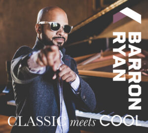 Promotional image showing a stylishly dressed person wearing sunglasses and pointing toward the camera while standing beside a piano. The background features a grand piano and warm, dramatic lighting. Vertical white text on the right reads “BARRON RYAN.” At the bottom, white text says “CLASSIC meets COOL,” emphasizing a blend of classical music and modern style.