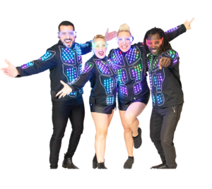 The frontline (4 vocalists) of Blonde Ambition pose, dressed in coordinated light-up jackets and glasses for Electric Light Party. (Background is transparent.)