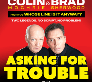 Promotional poster with a red background featuring comedians Colin Mochrie and Brad Sherwood. Large bold text reads: “Colin & Brad Mochrie Sherwood – From TV’s Whose Line Is It Anyway? Two Legends. No Script. No Problem! Asking for Trouble.”