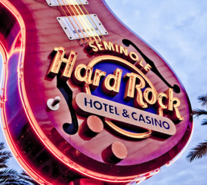 Guitar-shaped sign with neon light Seminole Hard Rock Hotel & Casino logo.