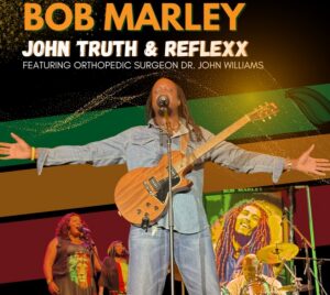 Promotional poster for John Truth & Reflexx: A Tribute Concert to Bob Marley. A performer is on stage with a guitar around his neck and his arms open. He appears to be singing into a microphone. Green, red, and yellow stripes along with a band are pictured behind him. Above him it reads "Tribute concert to Bob Marley... John Truth & Reflexx... Featuring orthopedic surgeon Dr. John Williams."