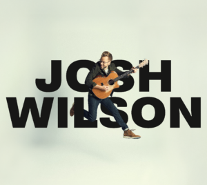 Josh Wilson holding guitar and jumping in mid air in front of text "Josh Wilson".