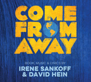 Poster for the musical Come From Away. The background is textured blue wood, with the title “COME FROM AWAY” in large, distressed yellow letters. The “O” in “FROM” is replaced with a small blue globe showing North and South America. Beneath the title, text reads “Book, Music & Lyrics by Irene Sankoff & David Hein.”