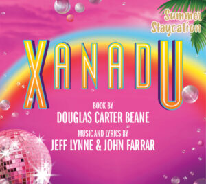 Bright pink poster for the musical Xanadu featuring a rainbow across the center and large colorful letters spelling “XANADU.” Disco balls sparkle in the corners with floating bubbles and tropical leaves, giving a summery disco vibe. Text reads: “Summer Staycation,” “Xanadu: Book by Douglas Carter Beane, Music and Lyrics by Jeff Lynne & John Farrar.”